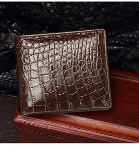 Detail of premium brown crocodile pattern leather wallet on dark luxury background