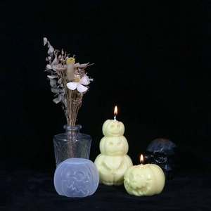 Detailed view of pumpkin silicone molds for Halloween candles with finished stacked wax