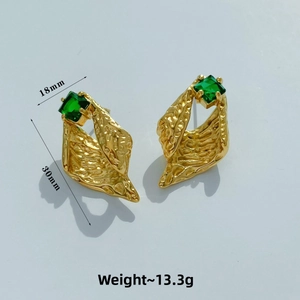 Detail view of gold geometric C-shape earring with green zircon and size measurements