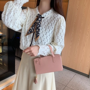 Pink double-layer leather crossbody bag with tassel and top handle for women