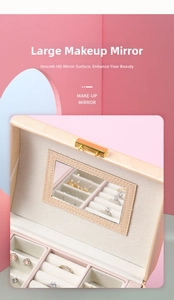 Detail view of the pink jewelry box featuring a built-in makeup mirror and soft velvet lining