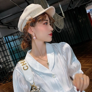 Elegant rabbit ear pearl earrings with 925 silver needles worn by model in chic outfit