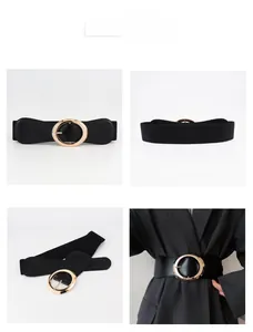 Detail view of women black elastic belt with large golden oval buckle for dresses