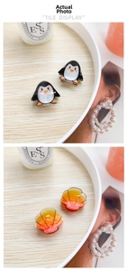 Detailed view of penguin and seashell acrylic hair claws on a wooden tray decor