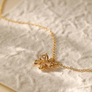 Close-up of a 18K gold-plated butterfly pendant necklace with sparkling zircon stones