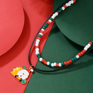 Close-up of double-layer Christmas necklace with Santa pendant and festive beads