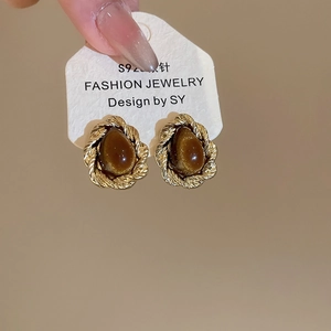 Detail showing S925 silver needle drop-shaped brown tiger eye stone earrings in gold
