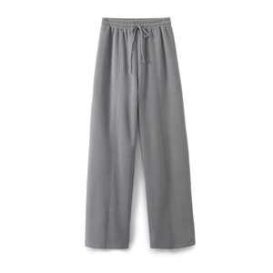 Detail of dark gray wide-leg sweatpants featuring elastic drawstring waist and front seams