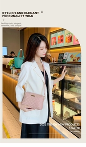 Pink quilted crossbody bag with metal logo detail worn by model in a cafe setting