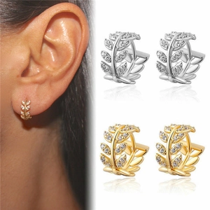 Sparkling leaf branch huggie earrings with cubic zirconia in gold and silver finishes