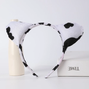 Detail of plush cow print animal ear headband with black and white spots for cosplay