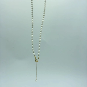 Detail of round pearl necklace with 14k gold-filled lobster clasp and extender