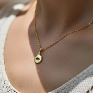 Vintage s925 silver necklace featuring a pigeon blood red stone evil eye pendant on a model