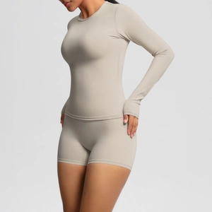 Close-up of nude long-sleeved yoga top with thumbholes and high-waisted shorts set