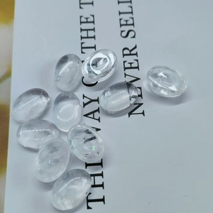 Macro detail of transparent oval amethyst stones scattered on a white background card