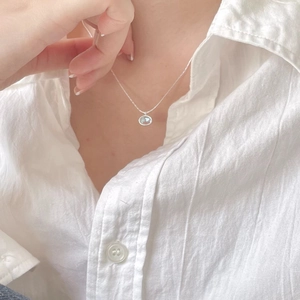 Minimalist 925 sterling silver necklace with a small round light blue crystal pendant