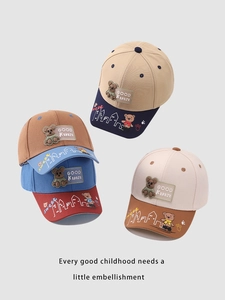 Detail view of cotton baseball caps with bear patches and urban skyline prints