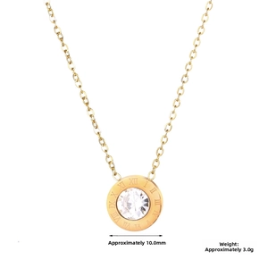 Detail of gold titanium necklace pendant with Roman numerals and central crystal