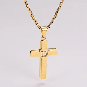 Detail of gold hollow cross pendant with engraved Lord's Prayer on stainless steel