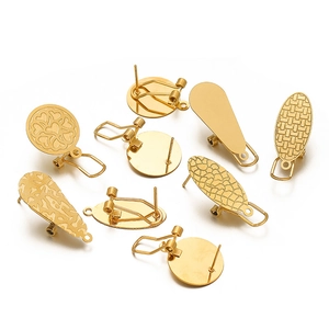 Close-up of golden geometric earring base findings in round, teardrop, and oval shapes