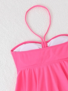 Detail of ribbed texture fabric and stitching on a hot pink halter neck swimwear