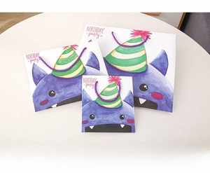Three-piece set of purple monster birthday paper gift bags in small, medium and large sizes