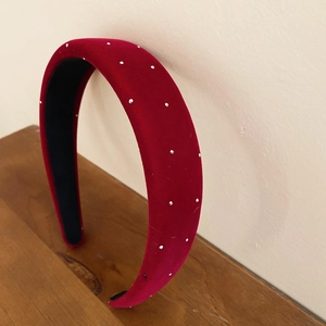 Detail of red velvet padded headband with crystal embellishments in retro style