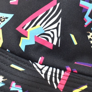 Macro detail of geometric diamond pattern and animal prints on the cotton bucket hat