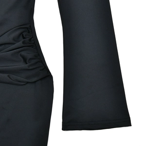 Close-up of black elastic fabric texture with stylish side ruching and pleated details