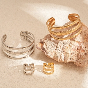 Layered open cuff bracelet and ring set in polished gold and silver metal finishes