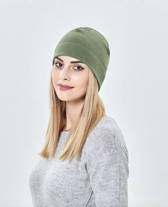 Close-up of olive green knitted running beanie on model for outdoor winter sports