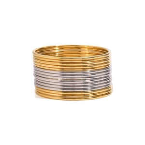 Polished gold and silver stainless steel thin bangles set stacked on white background