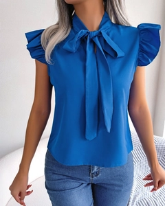 Detail of blue sleeveless chiffon shirt showing bow-tie collar and ruffle shoulder trim