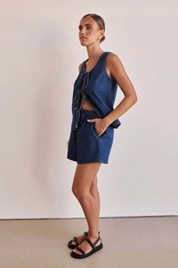 Detailed side view of dark blue denim two-piece set with sleeveless tie-up vest and shorts