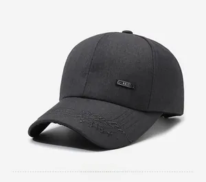 Detail of dark gray baseball cap featuring mountain embroidery and Fashion side label