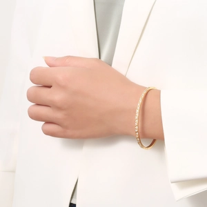Women's gold diamond-encrusted titanium steel bangle with geometric rhombus clasp design