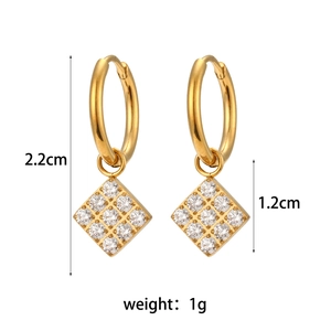 Detail view of gold hoop earrings with zircon star pendant and size measurements