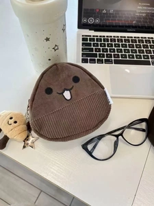 Plush chestnut storage pouch with cute facial embroidery and mini charm detail