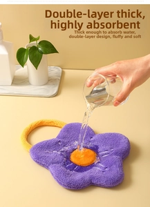 Detail of flower-shaped absorbent coral fleece towel showing water absorption and texture