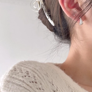 Minimalist 925 sterling silver geometric arc stud earrings worn by a model on the ear