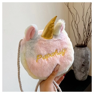 Close-up of rainbow plush unicorn bag featuring a golden horn and soft texture