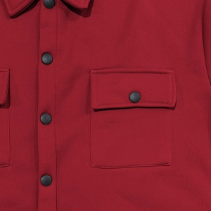 Detailed close-up of dark red fleece jacket collar with black buttons and fabric texture