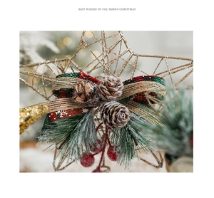 Detail of gold wire Christmas tree topper star with rustic bow, pinecones and red berries