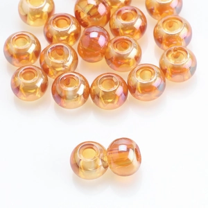 Macro detail of amber orange glass beads with iridescent finish for DIY jewelry