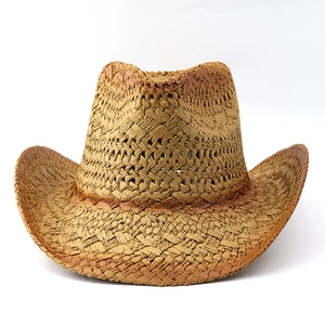 Detail of woven straw cowboy hat with textured pattern and rolled brim for sun protection