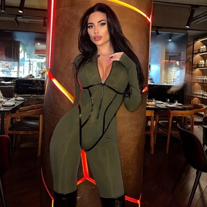 Slim fit dark green long sleeve jumpsuit with black contrast trim and front zipper design