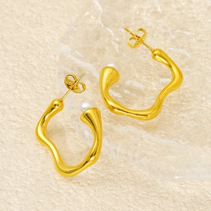 Irregular gold wave earrings with white pearls and polished stainless steel finish