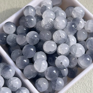 Macro shot of 10mm grey-white gradient ice-cracked glass beads for DIY jewelry making