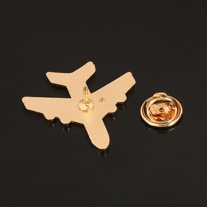 Macro shot of 3D airplane brooch back detail showing golden finish and butterfly clutch