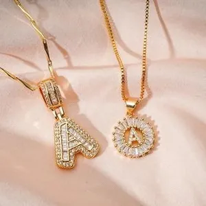 Detail of 18K gold letter A pendant necklace set with sparkling zircon on silk